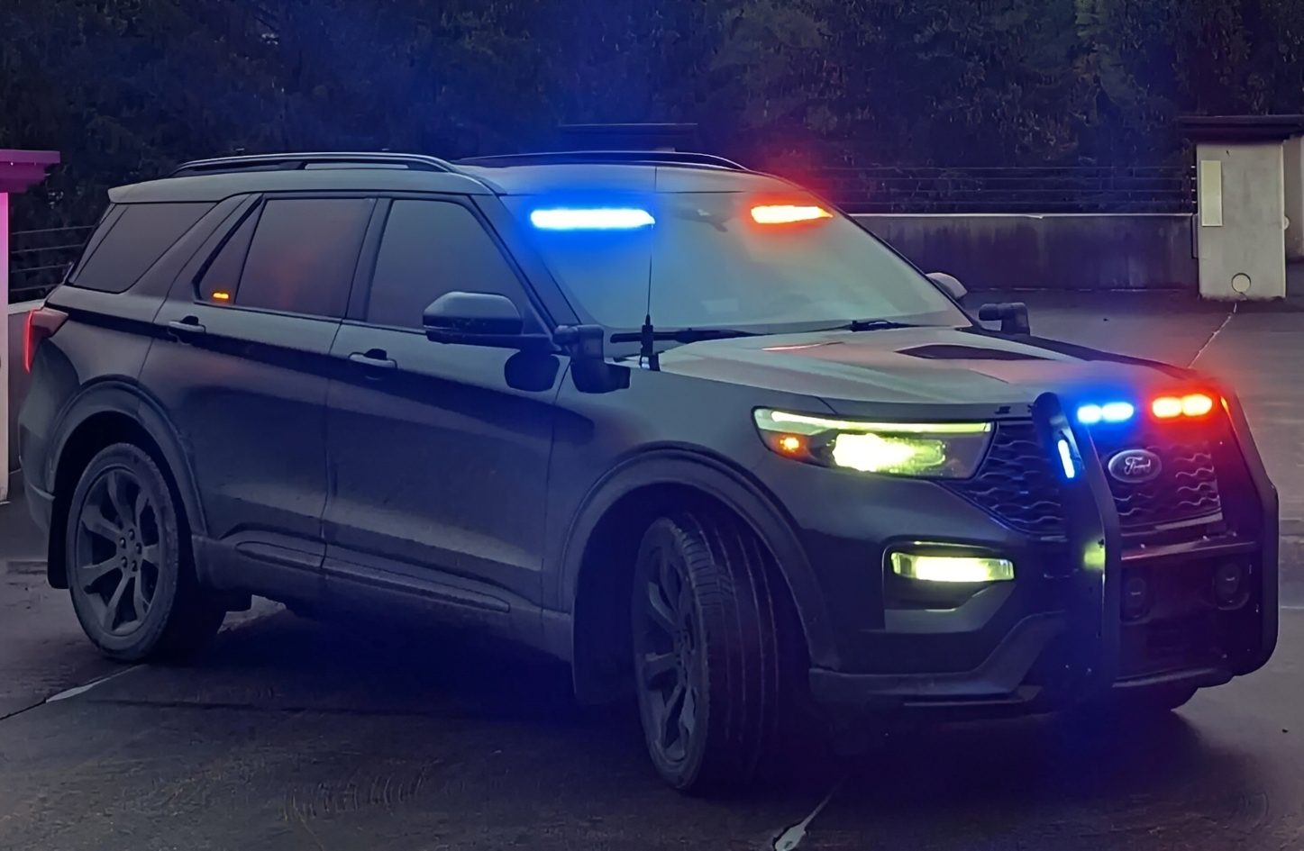 Police SUV with flashing lights at night.