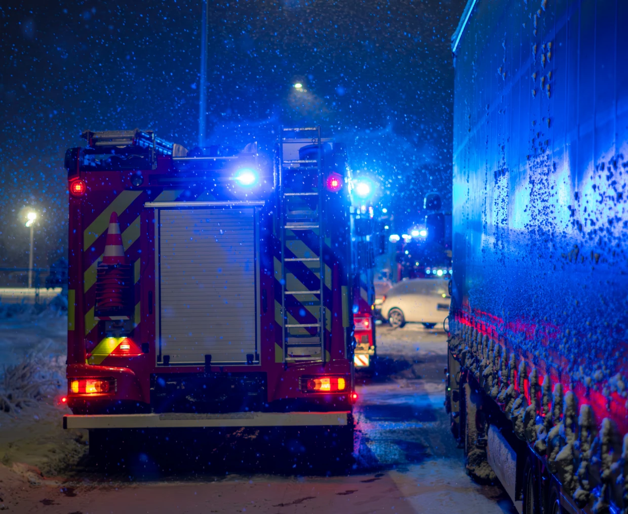 Emergency vehicles on snowy road