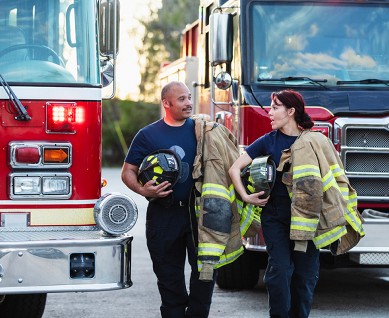Firefighters conversing near emergency vehicles