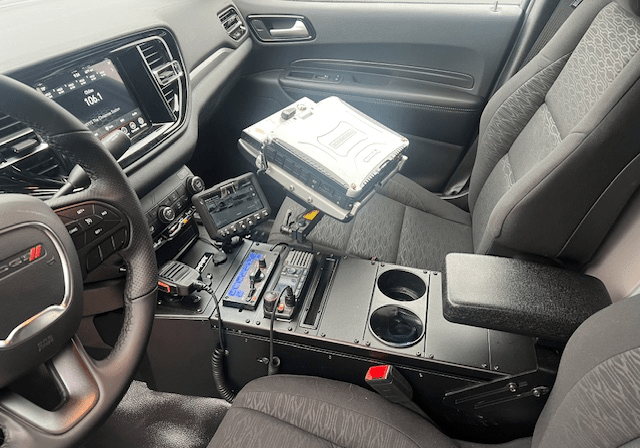 Police vehicle interior with electronic equipment.