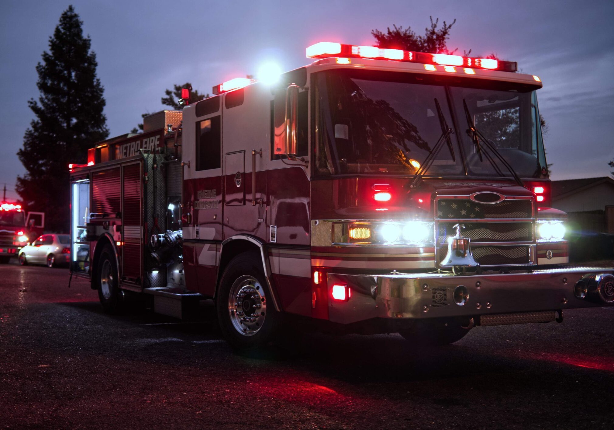 A fire truck with flashing lights at night.